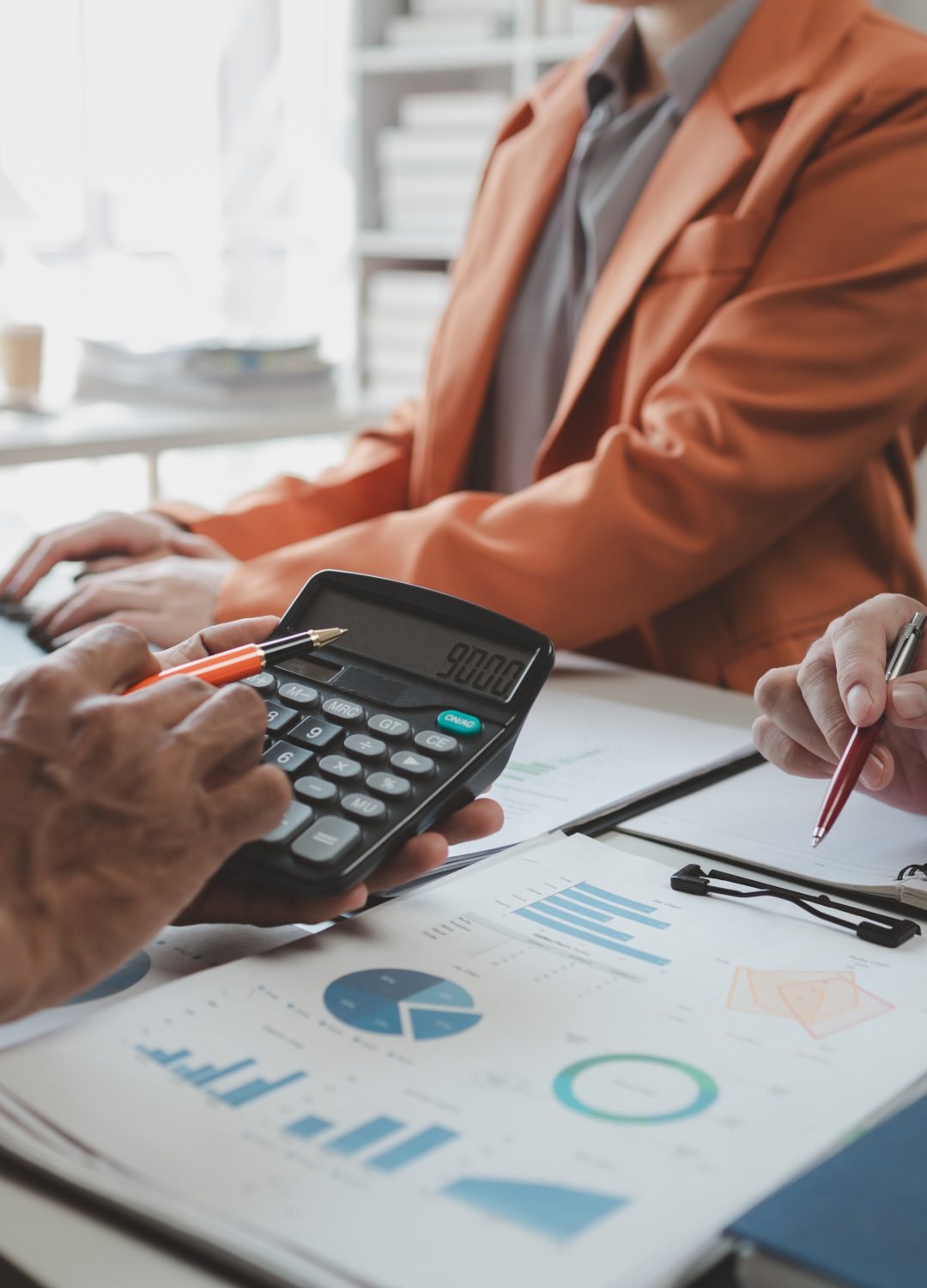 Calculate the numbers according to the report sent to the meeting, They are calculating the taxes they have to pay, They are having a meeting about the company's income and expenses,